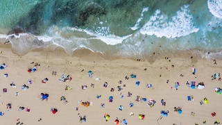  Spain, Mallorca, Cala Mesquida, Aerial view of people relaxing on Cala Agulla beach in summer AMF08433