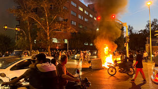 A police motorcycle burns during a protest over the death of Mahsa Amini, a woman who died after being arrested by the Islamic republic's morality police, in Tehran, Iran September 19, 2022. WANA (West Asia News Agency) via REUTERS ATTENTION EDITORS - THIS IMAGE HAS BEEN SUPPLIED BY A THIRD PARTY.   ATTENTION EDITORS - THIS PICTURE WAS PROVIDED BY A THIRD PARTY