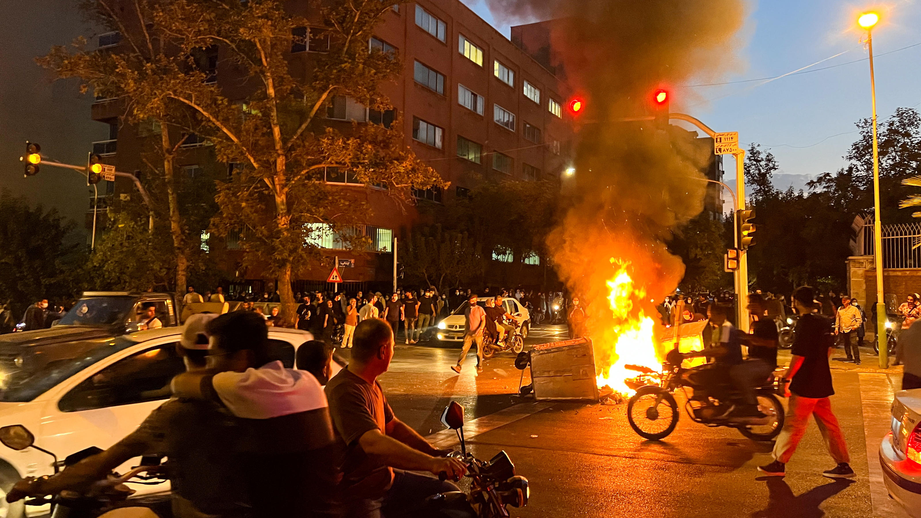 A police motorcycle burns during a protest over the death of Mahsa Amini, a woman who died after being arrested by the Islamic republic's morality police, in Tehran, Iran September 19, 2022. WANA (West Asia News Agency) via REUTERS ATTENTION EDITORS 
