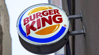 FILE - The Burger King logo is displayed on a sign outside a restaurant in downtown Pittsburgh on Wednesday, Jan. 12, 2022. On Friday, Sept. 9, 2022, the company said it plans to invest $400 million in its U.S. restaurants over the next two years to update its stores and boost flagging sales. (AP Photo/Gene J. Puskar, File)