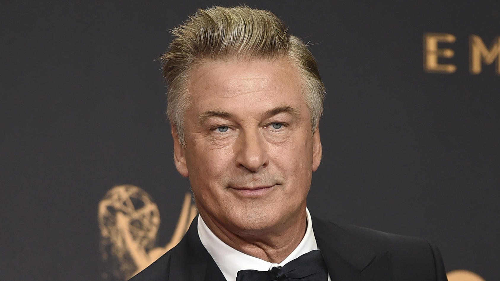 FILE - Alec Baldwin poses in the press room with the award for outstanding supporting actor in a comedy series for "Saturday Night Live" at the 69th Primetime Emmy Awards in Los Angeles on Sept. 17, 2017. The family of a cinematographer shot and kill
