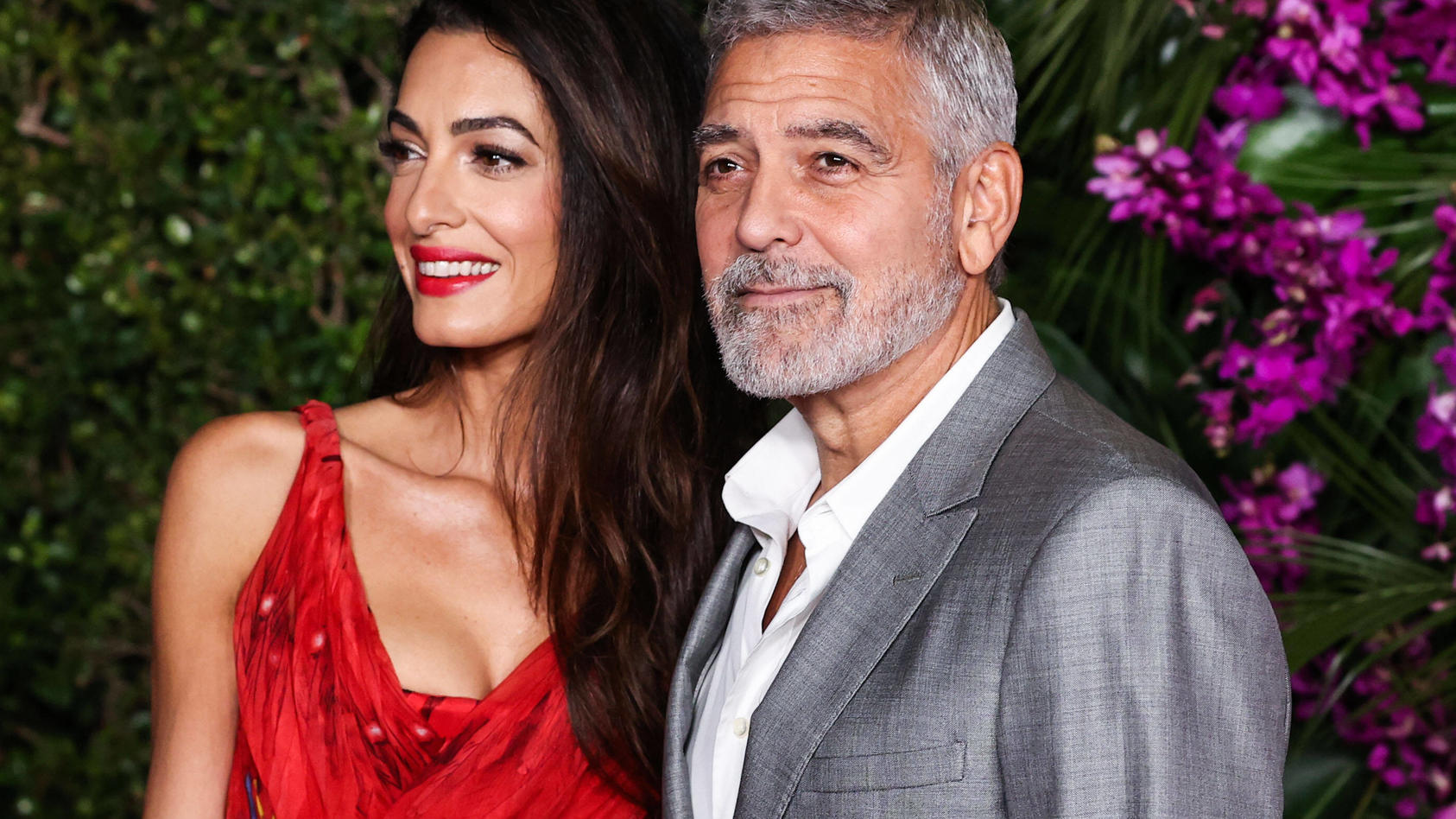  Los Angeles Premiere Of Universal Pictures Ticket To Paradise Lebanese-British barrister Amal Alamuddin Clooney wearing an Alexander McQueen dress and husband/American actor and filmmaker George Clooney arrive at the Los Angeles Premiere Of Universa