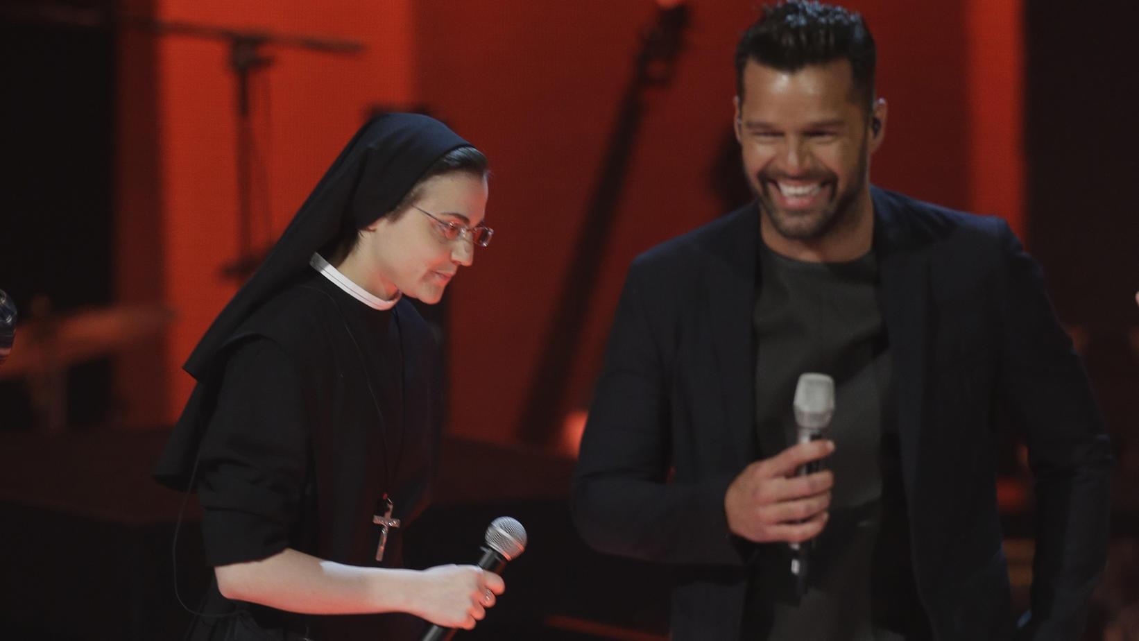 Italian singer Suor Cristina Scuccia, left, and Ricky Martin perform during the Italian State RAI TV program The Voice of Italy, in Milan, Italy, Wednesday, May 28, 2014. (AP Photo/Luca Bruno)