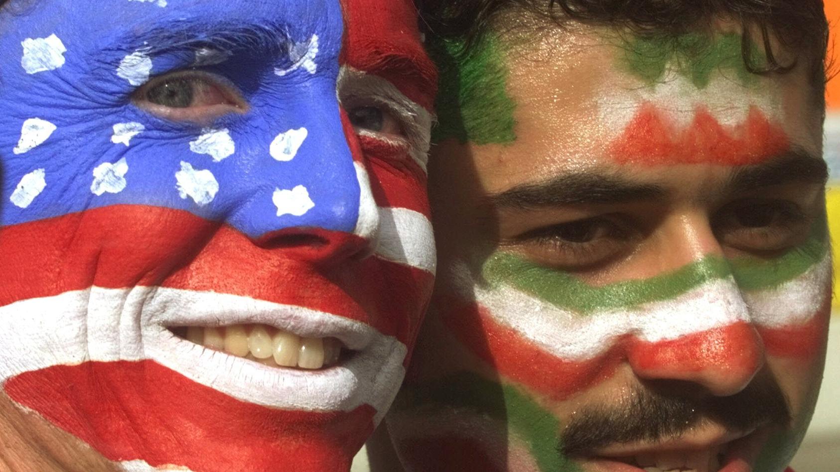 FILE - Mike Moscrop, left, from Orange County, Calif., poses with Amir Sieidoust, an Iranian supporter living in Holland outside the Gerlain Stadium in Lyon, June 21, 1998, before the start of the USA vs Iran World Cup soccer match. Iran defeated the