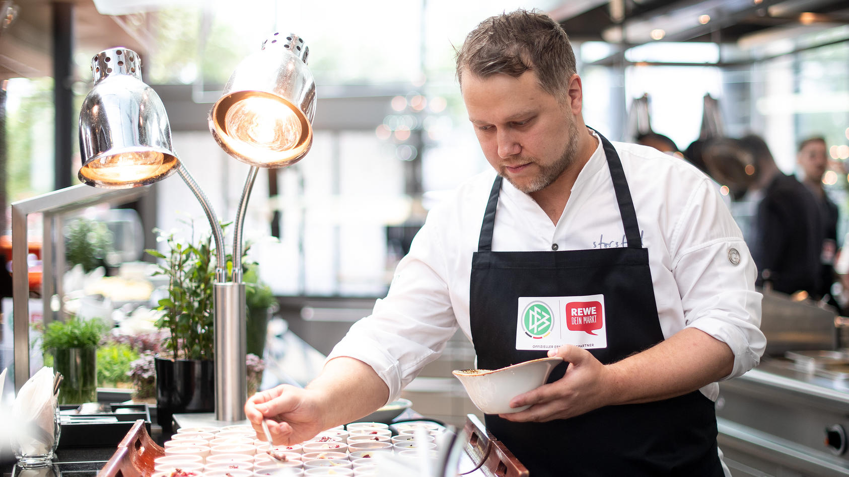 Auch Nationalspieler dürfen Nachtisch essen: DFB-Koch Anton Schmaus bereitet ihn hier 2019 zu.