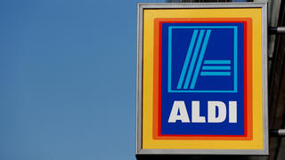 FILE PHOTO: FILE PHOTO: A company logo is pictured outside a branch of an Aldi supermarket in Manchester, Britain, March 17, 2016. REUTERS/Phil Noble/File Photo/File Photo