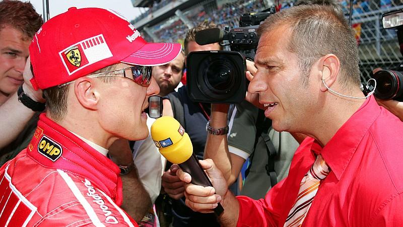 German Formula One driver Michael Schumacher (L) of Scuderia Ferrari answers questions of German TV-presentator Kai Ebel before the Grand Prix of Spain at the F1 race track Circuit de Catalunya in Montmelo near Barcelona, Spain, Sunday 14 May 2006. P