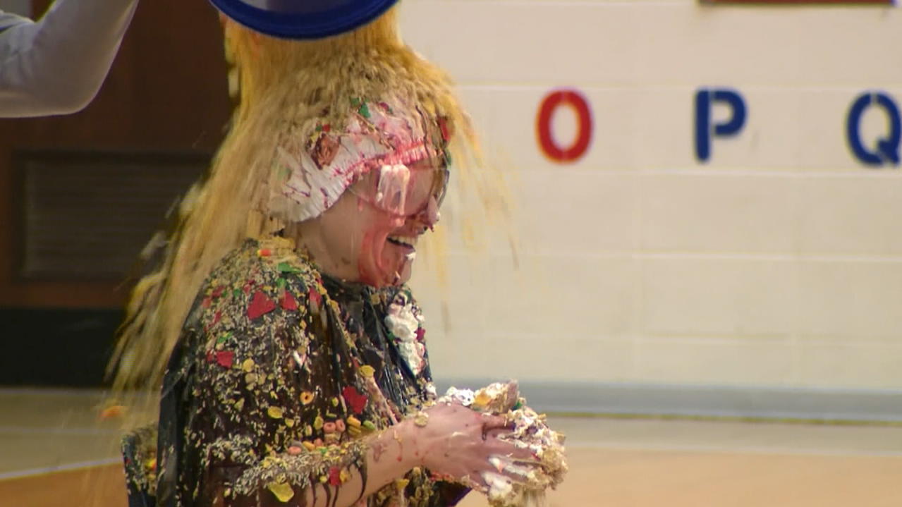 Covered with cream and chocolate sauce!  Pupils turn the headmistress into an ice queen