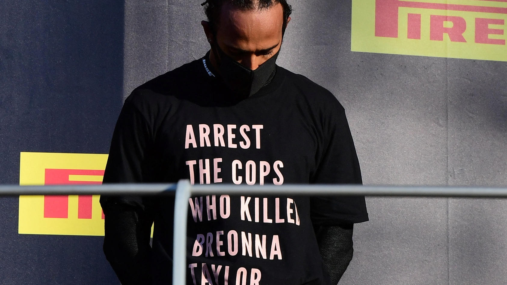 FILE PHOTO: Formula One F1 - Tuscan Grand Prix - Mugello, Scarperia e San Piero, Italy - September 13, 2020 Mercedes' Lewis Hamilton wears a shirt in reference to Breonna Taylor on the podium as he celebrates after winning the race Pool via REUTERS/J