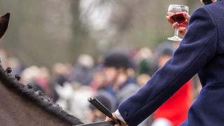 Ð¡irencester, England - December 26, 2018: Woman Horse rider taking a tipple of Port at the annual Boxing day hunt, held in Cirencester Park, Gloucestershire, England