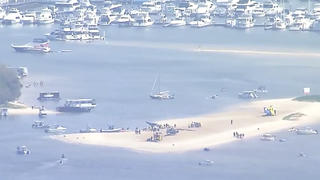 This image made from a video shows sand bank with crashed helicopter on Gold Coast, Australia Monday, Jan. 2, 2023. Two helicopters collided Monday afternoon over the Australian beach. (Australian Broadcasting Corp. via AP)