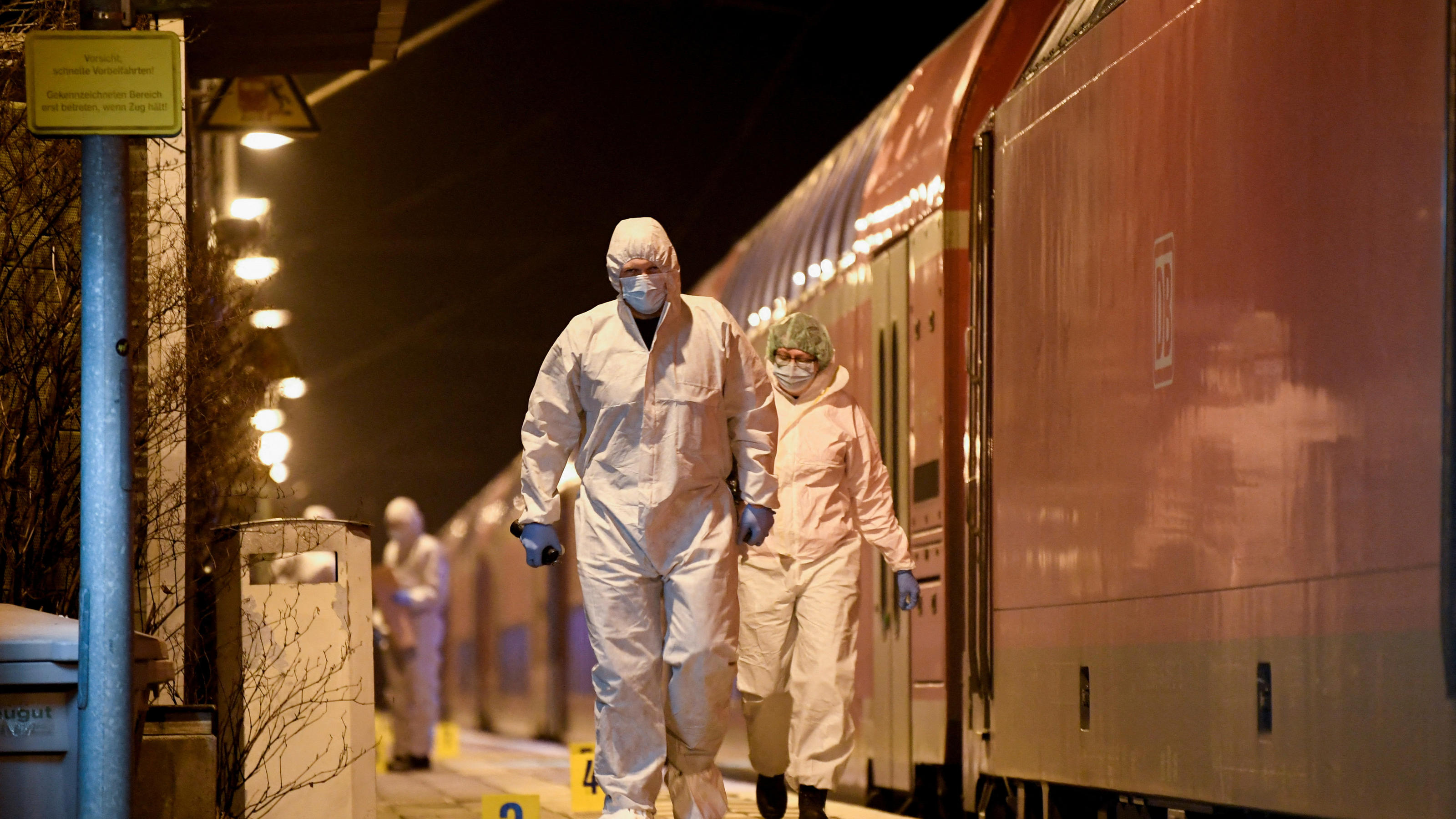 Forensic experts walk next to a train on which an incident involving a knife attack took place, at a railway station in Brokstedt, Germany, January 25, 2023.   REUTERS/Fabian Bimmer     TPX IMAGES OF THE DAY