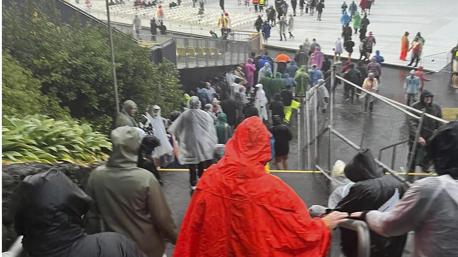 Fans leave Mt Smart Stadium in Auckland, New Zealand, Friday, Jan. 27, 2023, where about 40,000 people were expected to attend an Elton John concert. Torrential rain and wild weather in Auckland causes disruptions throughout the city and an Elton Joh