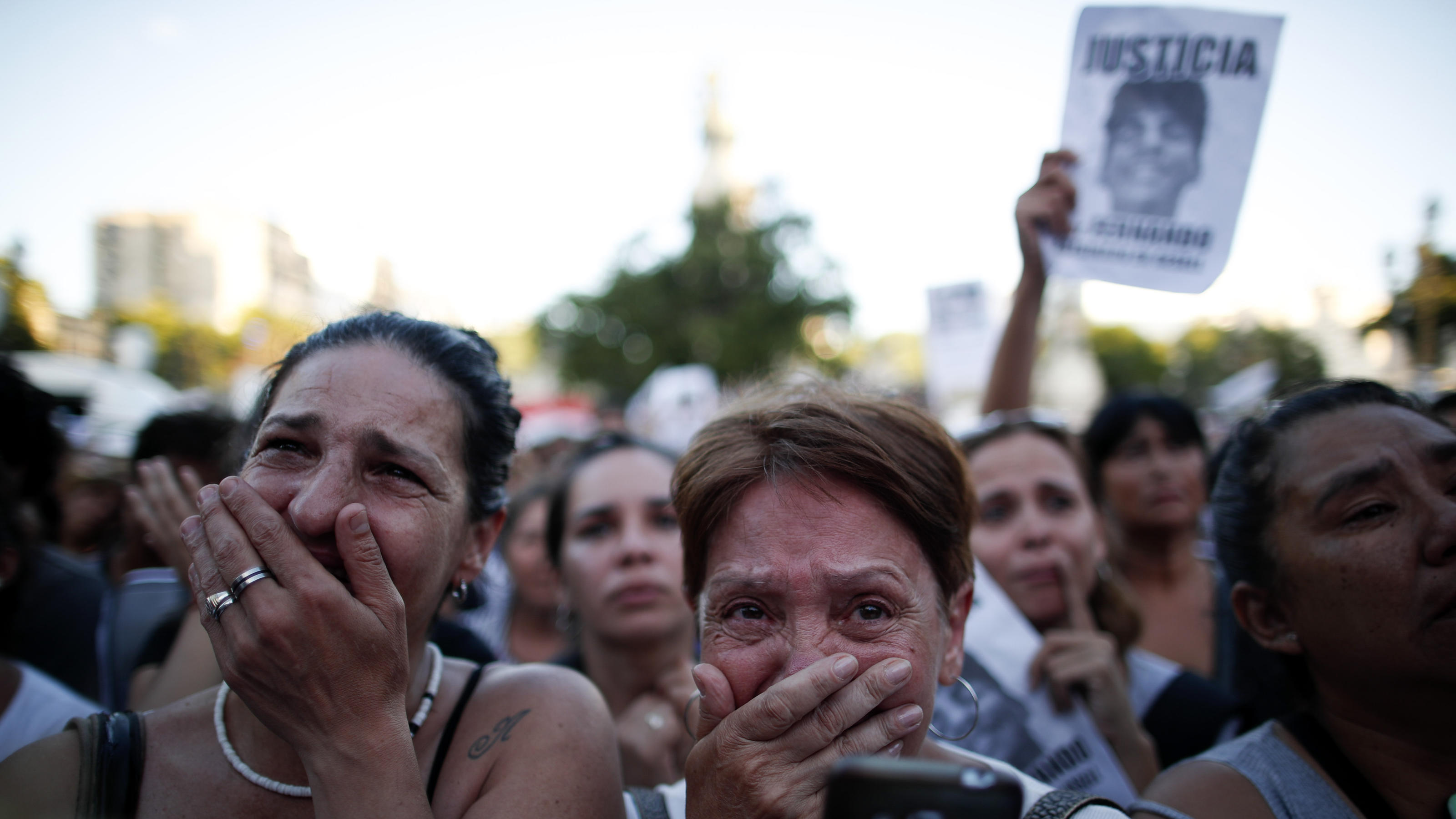 Women cry outside Congress demanding justice for Fernando Baez Sosa during a protest outside Congress one month after the 18-year-old's death, in Buenos Aires, Argentina, Tuesday, Feb. 18, 2020. According to an attorney on the case, Baez Sosa was bea
