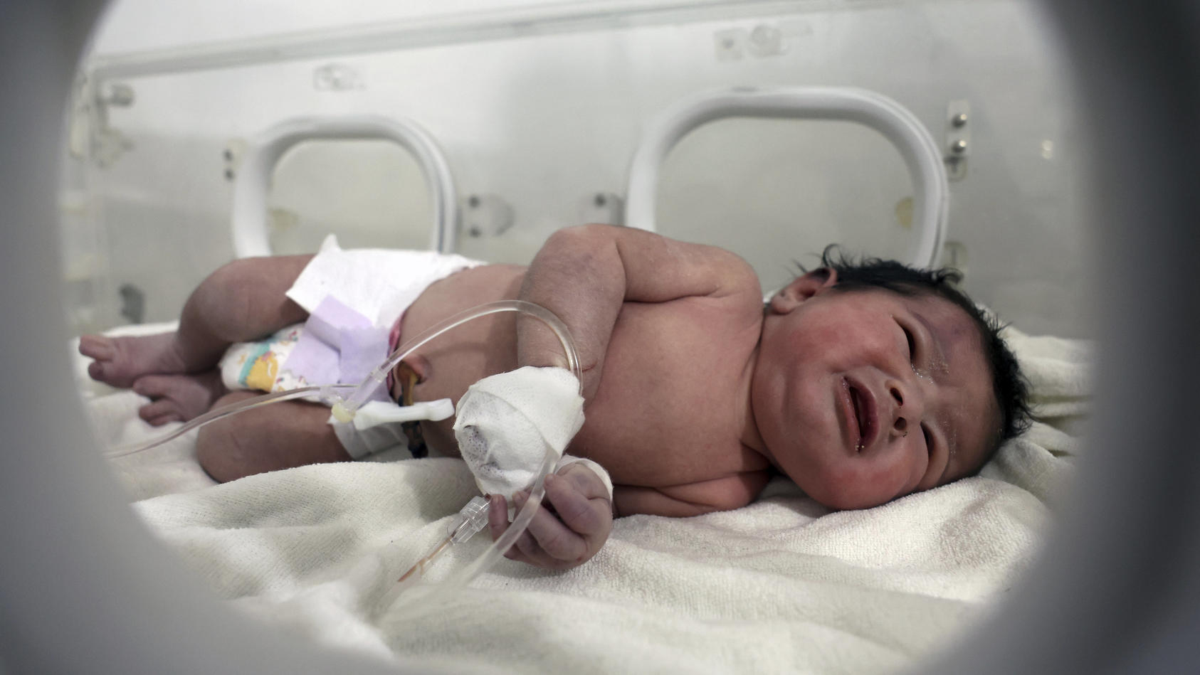 A baby girl who was born under the rubble caused by an earthquake that hit Syria and Turkey receives treatment inside an incubator at a children's hospital in the town of Afrin, Aleppo province, Syria, Tuesday, Feb. 7, 2023. Residents in the northwes