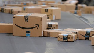 FILE PHOTO: Packages emblazoned with Amazon logos travel along a conveyor belt inside of an Amazon fulfillment center in Robbinsville, New Jersey, U.S., November 27, 2017.  REUTERS/Lucas Jackson/File Photo