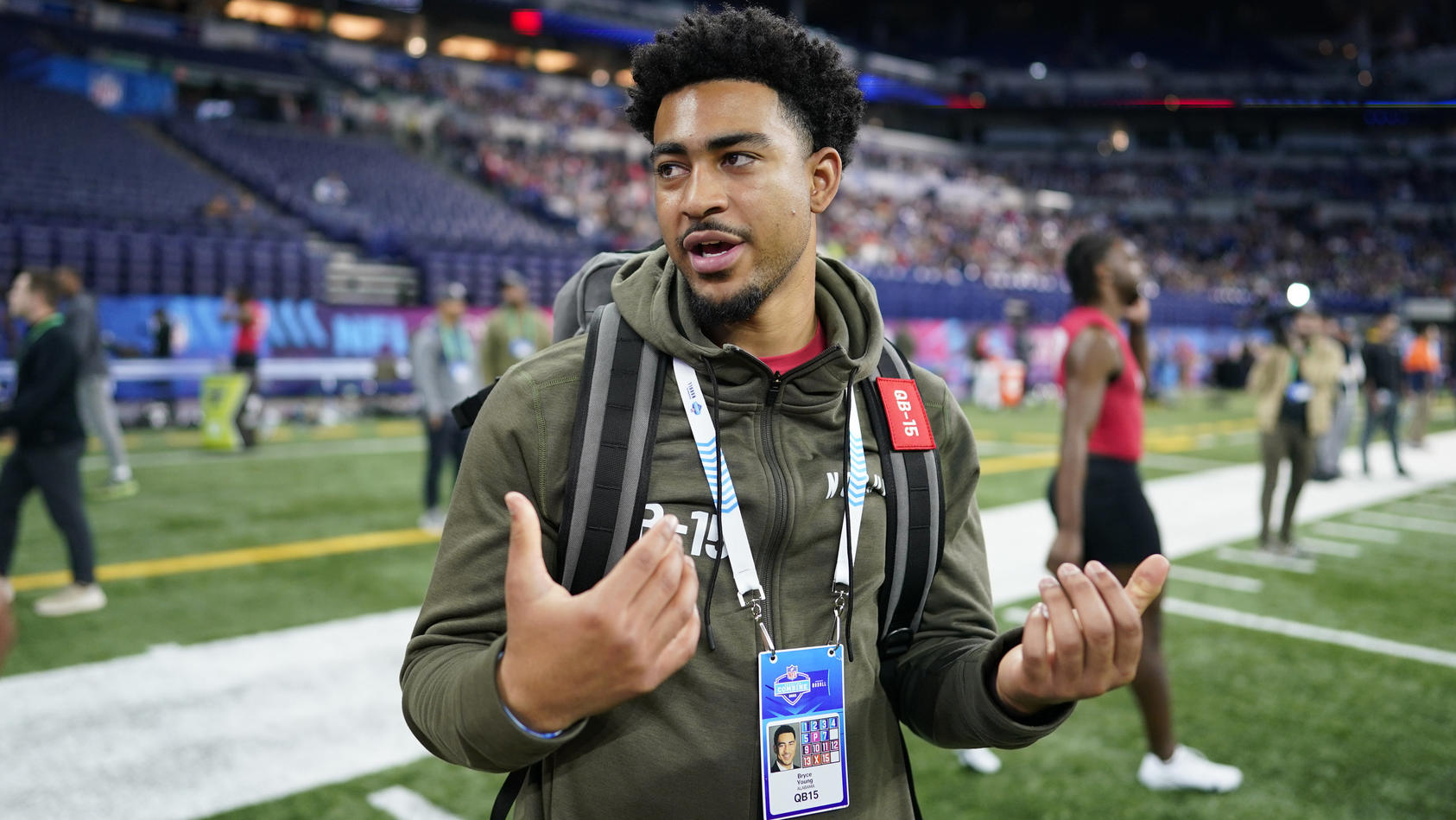 Alabama quarterback Bryce Young talks on the field during the NFL football scouting combine in Indianapolis, Saturday, March 4, 2023. (AP Photo/Darron Cummings)
