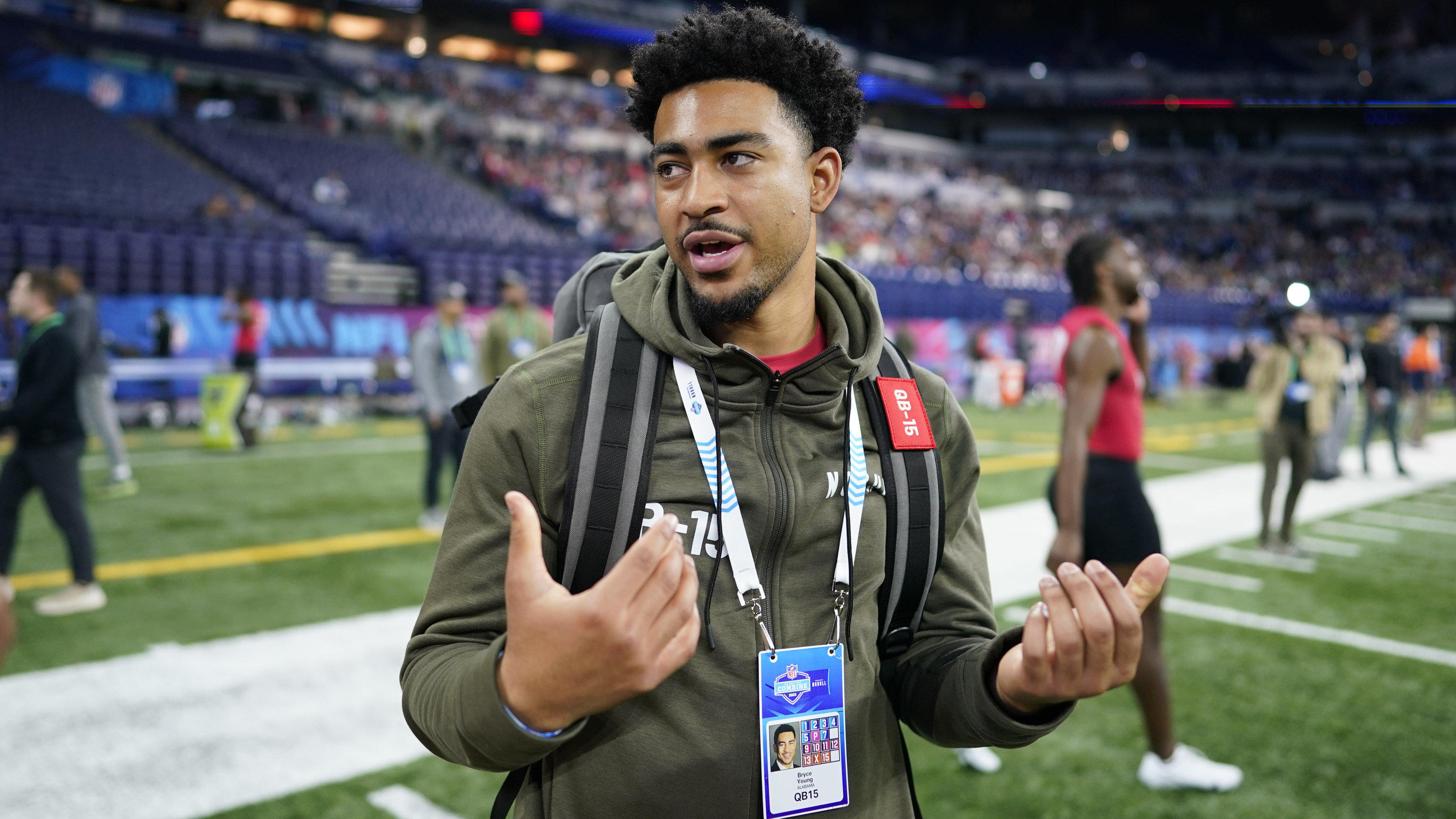 Alabama quarterback Bryce Young talks on the field during the NFL football scouting combine in Indianapolis, Saturday, March 4, 2023. (AP Photo/Darron Cummings)