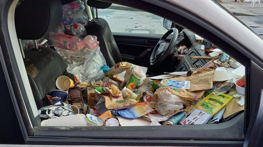 Polizisten haben ein Foto vom Inneren des VW Caddy gemacht.  Der gesamte Laderaum des war vollgeräumt mit Leergut und Müll. Der Fahrerbereich war zudem auch voll mit Zigarettenkippen, Zetteln, Verpackungsmaterialien und Pfandflaschen.