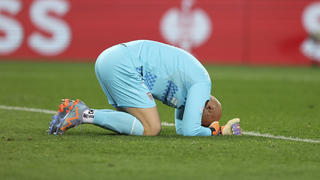 Sevilla's goalkeeper Marko Dmitrovic lies on the field during the Europa League round of 16 second leg soccer match between Fenerbahce and Sevilla at Sukru Saracoglu stadium in Istanbul, Turkey, Thursday, March 16, 2023. (AP Photo)
