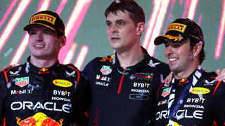 JEDDAH, SAUDI ARABIA - MARCH 19: Race winner Sergio Perez of Mexico and Oracle Red Bull Racing (R), Second placed Max Verstappen of the Netherlands and Oracle Red Bull Racing (L) and Ben Waterhouse, Head of Performance Engineering at Red Bull Racing, celebrate on the podium during the F1 Grand Prix of Saudi Arabia at Jeddah Corniche Circuit on March 19, 2023 in Jeddah, Saudi Arabia. (Photo by Lars Baron/Getty Images)