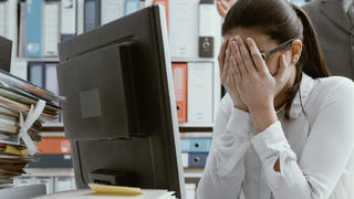 Angry boss yelling at his young employee, she is stressed and feeling frustrated: bullying boss and mobbing concept