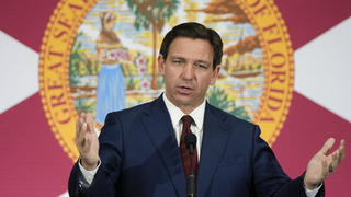 FILE - Florida Gov. Ron DeSantis speaks during a news conference in Miami, Tuesday, May 9, 2023. Videos circulating on social media purport to show empty Florida grocery stores due to a boycott of truck drivers over an immigration bill recently signed by DeSantis. However, while some truckers have threatened to stop deliveries in the state, these grocery aisles are empty for reasons that are unrelated to the recent bill. (AP Photo/Rebecca Blackwell, File)