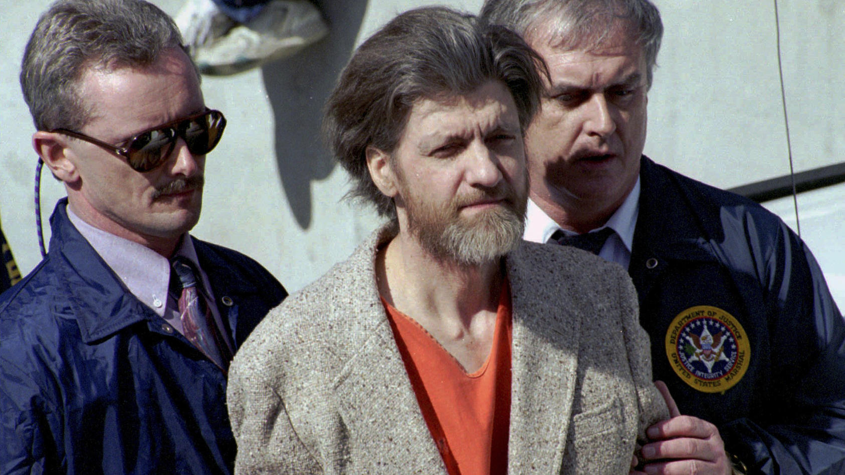 FILE - Theodore "Ted" Kaczynski is flanked by federal agents as he is led to a car from the federal courthouse in Helena, Mont., April 4, 1996. A spokesperson for the Bureau of Prisons on Saturday, June 10, 2023, told The Associated Press that Kaczyn