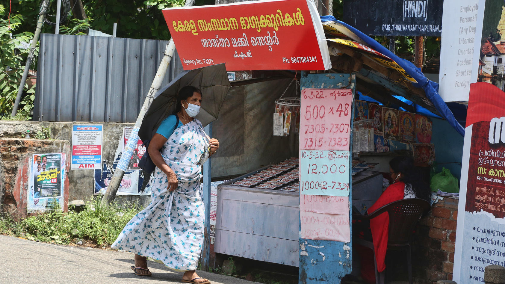 A small stand in India sells lottery tickets on the road.