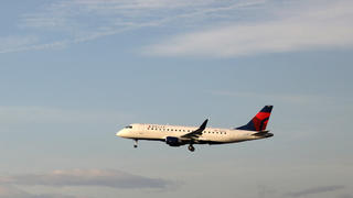 FILE PHOTO: A Delta Connection Embraer ERJ-175LR plane lands as a United Express Embraer ERJ-175LR plane waits to take off at LAX airport in Los Angeles, California U.S. January 10, 2018. REUTERS/Lucy Nicholson/File Photo