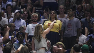 An audience member yells at protesters as they demonstrate at a match between Coco Gauff, of the United States, and Karolina Muchova, of the Czech Republic, during the women's singles semifinals of the U.S. Open tennis championships, Thursday, Sept. 7, 2023, in New York. (AP Photo/Frank Franklin II)