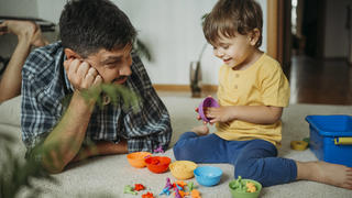Smiling father and son playing with plastic toys at home model released, Symbolfoto property released, ANAF01813