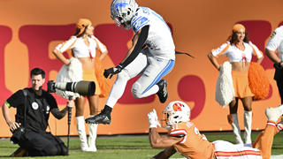 Detroit Lions wide receiver Amon-Ra St. Brown (14) avoids the tackle of Tampa Bay Buccaneers safety Antoine Winfield Jr. (31) on a 27-yard touchdown reception during the first half of an NFL football game Sunday, Oct. 15, 2023, in Tampa, Fla. (AP Photo/Jason Behnken)
