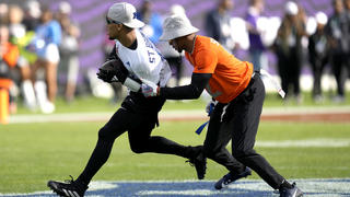 NFC Amon-Ra St. Brown, of the Detroit Lions, is stopped by AFC cornerback Pat Surtain II, of the Denver Broncos, right, during the flag football event at the NFL Pro Bowl football game, Sunday, Feb. 4, 2024, in Orlando. (AP Photo/John Raoux)
