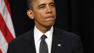 U.S. President Barack Obama looks down as he walks from the rostrum after speaking at a vigil held at Newtown High School for families of victims of the Sandy Hook Elementary School shooting in Newtown, Connecticut December 16, 2012. Obama on Sunday consoled the Connecticut town shattered by the massacre of 20 young schoolchildren, lauding residents' courage in the face of tragedy and saying the United States was not doing enough to protect its children. REUTERS/Kevin Lamarque (UNITED STATES - Tags: POLITICS CRIME LAW EDUCATION)