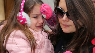 Suri Cruise cries after dropping her stuffed animal when heading to the Music Box theater with mom Katie Holmes in NYC.