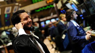 NEW YORK, Dec. 31, 2011 A trader works on the main trading floor of the New York Stock Exchange during the last trading day of 2011 in New York Dec. 30, 2011. (Xinhua/Shen Hong