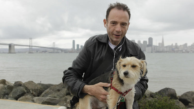 This May 16, 2011 photo shows Timothy Ray Brown, the only man ever known to have been apparently cured from AIDS, with his dog, Jack, on Treasure Island in San Francisco. Brown was in a Berlin hospital in 2007, worrying whether leukemia or the AIDS v