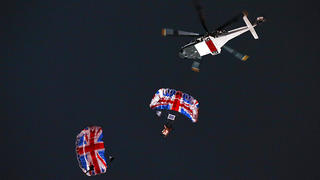 (FILE PHOTO) Skydiver Mark Sutton who parachuted into the Olympic Stadium dressed as James Bond as part of the London 2012 Opening Ceremony has died in an wing-diving accident LONDON, ENGLAND - JULY 27:  Gary Connery and Mark Sutton parachute into the stadium as part of short James Bond film featuring Daniel Craig and The Queen during the Opening Ceremony of the London 2012 Olympic Games at the Olympic Stadium on July 27, 2012 in London, England.  (Photo by Cameron Spencer/Getty Images)
