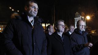 German Foreign Minister Guido Westerwelle (C), heavyweight boxing champion and UDAR (Ukrainian Democratic Alliance for Reform) party leader Vitali Klitschko (L) and former economy minister and head of the union of Ukrainian opposition parties Arseny Yatsenyuk walk along a street after a meeting in Kiev December 4, 2013. Urbane liberals are joining black-booted skinheads to protest on the streets of Kiev, but if the Orange Revolution of nine years ago is to be repeated, they need a leader to unite them. Enter Vitaly Klitschko, a towering world boxing champion with a doctorate in sports science, who is looking increasingly like the opposition's most powerful contender. REUTERS/Vasily Fedosenko (UKRAINE - Tags: SPORT BOXING POLITICS CIVIL UNREST)