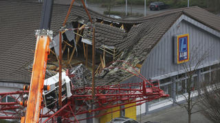Teilweise eingestürzt ist am 11.12.2013 in Bad Homburg (Hessen) das Dach eines Supermarktes, nachdem ein Kran hineingestürzt war. Die Polizei sprach zunächst von mehreren Verletzten,. Foto: Frank Rumpenhorst/dpa +++(c) dpa - Bildfunk+++