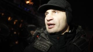 Heavyweight boxing champion and UDAR (Ukrainian Democratic Alliance for Reform) party leader Vitaly Klitschko walks past a riot police line in Kiev December 11, 2013. Ukrainian riot police reoccupied part of the square in central Kiev on Wednesday where protesters have been demonstrating against the government's decision to pull out of negotiations on a trade pact with the European Union and rebuild economic ties with Russia. REUTERS/Vasily Fedosenko (UKRAINE - Tags: POLITICS CIVIL UNREST SPORT BOXING)