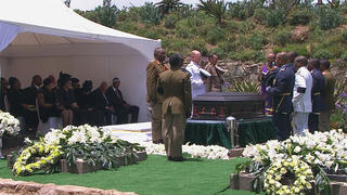 A member of military speaks at the burial site of former South African President Nelson Mandela in his ancestral village of Qunu in the Eastern Cape province, 900 km (559 miles) south of Johannesburg, in this still image taken from December 15, 2013 video courtesy of the South Africa Broadcasting Corporation (SABC). REUTERS/SABC via Reuters TV    (SOUTH AFRICAPOLITICS OBITUARY - Tags: POLITICS OBITUARY TPX IMAGES OF THE DAY)ATTENTION EDITORS - FOR EDITORIAL USE ONLY. NOT FOR SALE FOR MARKETING OR ADVERTISING CAMPAIGNS. NO SALES. NO ARCHIVES. SOUTH AFRICA OUT. NO COMMERCIAL OR EDITORIAL SALES IN SOUTH AFRICA. THIS PICTURE WAS PROCESSED BY REUTERS TO ENHANCE QUALITY