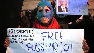 A demonstrator holds a placard supporting Pussy Riot in front of Quirinale palace in Rome, as Russia's President Vladimir Putin visits his Italian counterpart Giorgio Napolitano, November 25, 2013. Putin is on a two-day visit to Italy and Vatican. REUTERS/Yara Nardi ( ITALY - Tags: POLITICS CIVIL UNREST)