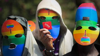 epa04098849 (FILE) A file picture dated 10 Februatry 2014 shows a masked Kenyan supporter of the LGBT community holds a condom as he joins others in protest against Uganda's anti-gay bill in front of the Ugandan High Commission in Nairobi, Kenya. Uganda?s President Yoweri Museveni signed into law on 24 February 2014 anti-gay legislation that allows homosexuals to be punished with up to life in prison. The law has come under strong criticism abroad, with US President Barack Obama warning that it could 'complicate' Uganda?s relations with one of its biggest aid donors. EPA/DAI KUROKAWA