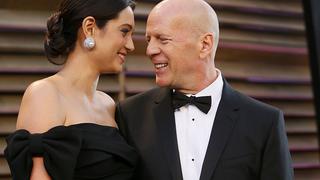 Actor Bruce Willis (R) and his wife Emma Heming arrive at the 2014 Vanity Fair Oscars Party in West Hollywood, California March 2, 2014.   REUTERS/Danny Moloshok (UNITED STATES  - Tags: ENTERTAINMENT)(OSCARS-PARTIES)