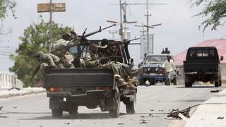 Somali government soldiers ride in their truck as they take up positions outside the Parliament building during a clash with Al Shabaab militants in the capital Mogadishu, May 24, 2014. Al Qaeda-linked militants attacked Somalia's parliament on Saturday, killing at least four people in a bomb and gun assault, the Islamist group and police said. REUTERS/Feisal Omar (SOMALIA - Tags: SOCIETY CIVIL UNREST POLITICS TPX IMAGES OF THE DAY)