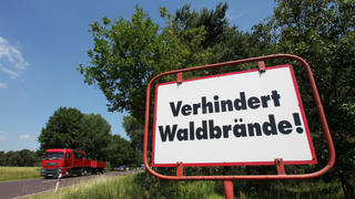 ARCHIV - Ein Schild mit der Aufschrift «Verhindert Waldbrände!» steht am 29.06.2010 am Rande der Bundesstraße 189 bei Colbitz in der Colbitz Letzlinger Heide (Sachsen-Anhalt). Das frühe Sommerwetter lässt die Gefahr von Waldbränden in Sachsen-Anhalt steigen. Foto: Jens Wolf/dpa (zu lah vom 21.05.2014) +++(c) dpa - Bildfunk+++