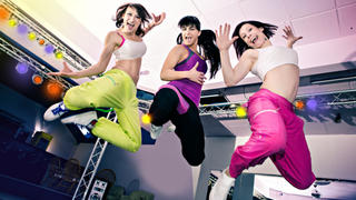 young women in sport dress at an aerobic and zumba exercise