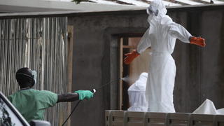 epa04338480 A picture made available 02 August 2014 shows Liberian nurses in protective clothing being spray with disinfectant after preparing several bodies of victims of Ebola for burial in the isolation unit of the ELWA Hospital in Monrovia, Liberia 01 August 2014. The World Health Organization warned of possibly 'catastrophic' consequences from the Ebola outbreak in West Africa. The WHO has announced a 100-million-dollar programme to fight the virus. Over 729 people have died of Ebola in West Africa in 2014, making it the world's deadliest outbreak to date according to statistics from the United Nations. EPA/AHMED JALLANZO +++(c) dpa - Bildfunk+++